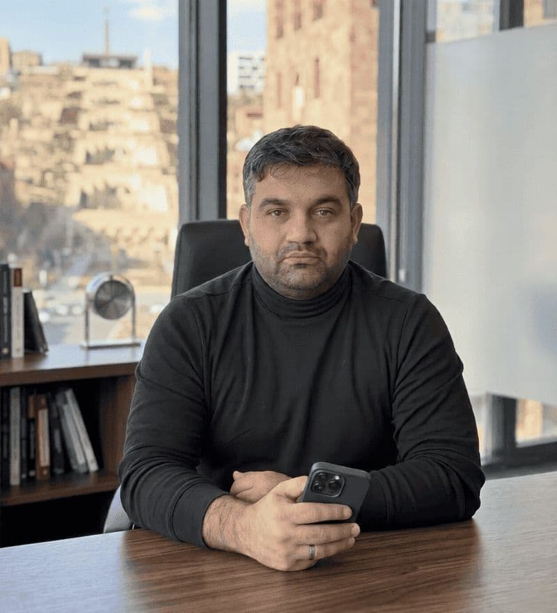 Hrayr Shahnazaryan, SEO Tech Developer, professional portrait in office with city view